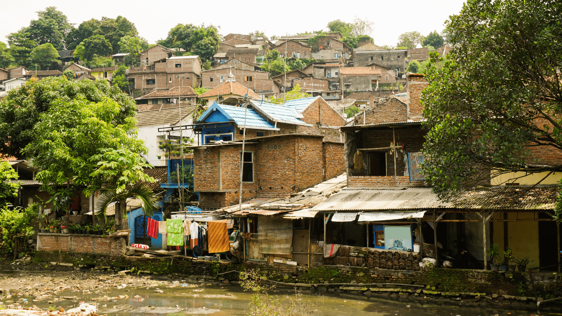 Slums near dirty river photo taken in Semarang Indonesia Java. 